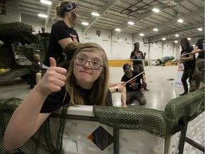 Children's Wish child Jane Reeves,15, and her team the Brave Hearts, try to hit targets with a bean bag catapult during the Heroes Challenge fundraiser for the Children's Wish Foundation of Canada at CFB Edmonton on Feb. 23, 2018.