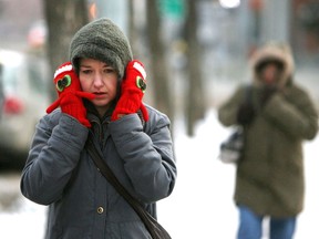 A pedestrian tries to keep her ears warm as she walks along 102 Avenue near 103 street. (File Photo)