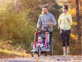 Family with baby in jogging stroller running outside in autumn nature for a story by Paul Robinson