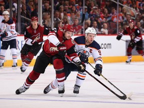 Oliver Ekman-Larsson (23) of the Arizona Coyotes and Connor McDavid (97) of the Edmonton Oilers skate after the puck at Gila River Arena on Jan. 12, 2018, in Glendale, Ariz. The Oilers defeated the Coyotes 4-2.