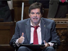 Ottawa-Vanier MP Mauril Belanger gives the thumbs up as he receives applause after using a tablet with text-to-speech program to defend his proposed changes to neutralize gender in the lyrics to "O Canada" in the House of Commons on Parliament Hill in Ottawa on Friday, May 6, 2016. The Senate has passed a bill to make the national anthem more gender neutral, fulfilling the dying wish of Liberal MP Belanger.