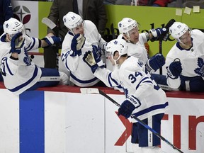 Maple Leafs centre Auston Matthews (34) is congratulated by teammates after scoring the eventual game-winning goal against the Red Wings in the third period on Sunday, Feb. 18, 2018, in Detroit.