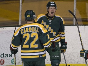 University of Alberta Golden Bears forward Luke Philp celebrates his goal with teammate Ben Carroll against the University of Calgary Dinos during the 2017 Canada West semifinals at Clare Drake Arena in Edmonton. (File)