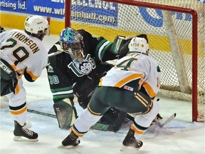 Ben Thomson, left, fires the puck past Saskatchewan goalie Thomas Vicars to give the U of A Golden Bears a 4-3 overtime victory in the 2005 Telus University Cup final.