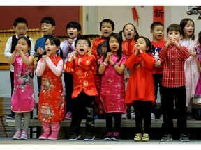 Grade 1 students perform a song during Chinese New Year celebrations at Meadowlark Elementary School in Edmonton on Friday, Feb. 16, 2018, the first day in the new Year of the Dog.