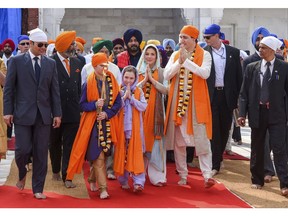 Canadian Prime Minister Justin Trudeau, third right, walks with his family members during their visit to Golden Temple, in Amritsar, India, Wednesday, Feb. 21, 2018. Trudeau is on a seven-day visit to India. (Public Relations Office Govt. Of Punjab via AP)