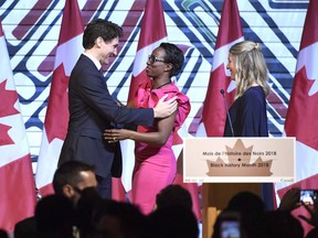 With an eye towards ultranationalist movements rising around the world, the Liberal government boosted funding in this week's federal budget to address issues of anti-immigrant sentiment and racism bubbling up at home. Prime Minister Justin Trudeau is welcomed by Parliamentary Secretary to the Minister of International Development Celina Caesar-Chavannes, as Minister of Canadian Heritage Melanie Joly looks on, during a Black History Month reception at the Museum of History in Gatineau, Que., on Monday, Feb. 12, 2018.