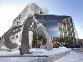 People enter the Law Courts in Winnipeg for the second degree murder trial of Raymond Cormier on Monday, February 5, 2018.