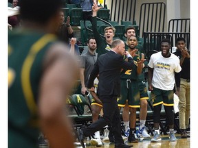 The University of Alberta Golden Bears bench celebrates a last-second basket against the UNBC Timberwolves during Canada West playoff quarterfinals at the Saville Sports Centre in Edmonton on Feb. 17, 2018. (Ed Kaiser)