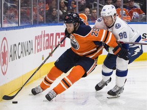 Tampa Bay Lightning' Mikhail Sergachev (98) and Edmonton Oilers' Leon Draisaitl (29) battle for the puck during second period NHL action in Edmonton, Alta., on Monday February 5, 2018.