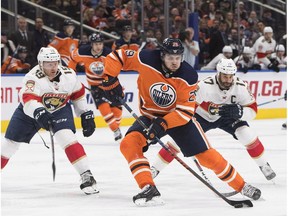 Florida Panthers defenceman Mike Matheson (19) and centre Derek MacKenzie (17) chase Edmonton Oilers forward Leon Draisaitl (29) in Edmonton on Feb. 12, 2018.