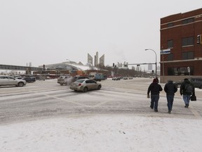 Pedestrians and drivers cross the intersection of 109 Street and 104 Avenue, a location for part of the west LRT line, in Edmonton, Alberta on Friday, Feb. 2, 2018.