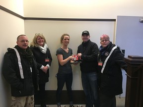 Brian Weber, left, Charlene Dufrat, Rachelle Mumm; Pete Howell and Christine Bannerman visit a women's shelter as part of the In Her Boots campaign by VETS Canada on Saturday, March 3, 2018.