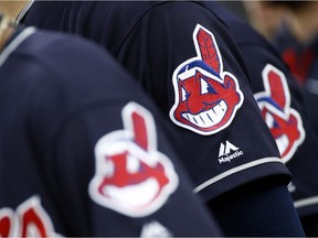 FILE - In this June 19, 2017 file photo, members of the Cleveland Indians wear uniforms featuring mascot Chief Wahoo as they stand on the field for the national anthem before a baseball game against the Baltimore Orioles in Baltimore. The Cleveland Indians are taking the divisive Chief Wahoo logo off their jerseys and caps, starting in 2019.