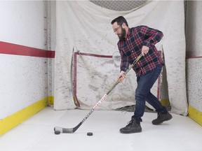 Reporter Juris Graney tries a hockey stick in the shooting lanes at United Cycle in Edmonton on Feb. 8, 2018.