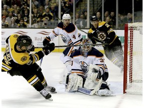 Boston Bruins center David Krejci (46) shoots past Edmonton Oilers goalie Cam Talbot (33) for a goal on an assist from Riley Nash (20) during the second period of an NHL hockey game in Boston, Sunday, Nov. 26, 2017.