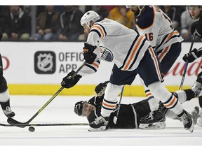 Los Angeles Kings left wing Tanner Pearson, below, reaches for the puck along with Edmonton Oilers right wing Zack Kassian on Wednesday, Feb. 7, 2018, in Los Angeles.
