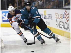 San Jose Sharks defenseman Marc-Edouard Vlasic (44) and Edmonton Oilers right wing Jesse Puljujarvi (98) race for the puck during the second period of an NHL hockey game Saturday, Feb. 10, 2018, in San Jose, Calif.