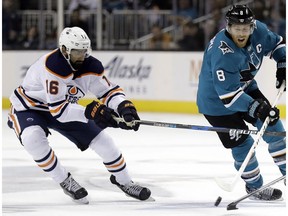 San Jose Sharks' Joe Pavelski, right, skates in front of Edmonton Oilers' Jujhar Khaira during the second period of an NHL hockey game Tuesday, Feb. 27, 2018, in San Jose, Calif.