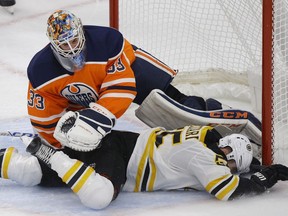 Boston Bruins Noel Acciari collides with Edmonton Oilers goalie Cam Talbot during NHL game action in Edmonton on Tuesday February 20, 2018.