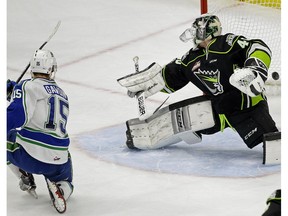 Swift Current Broncos captain Glenn Gawdin (left) scores on Edmonton Oil Kngs goalie Travis Child during WHL game action in Edmonton on Sunday December 10, 2017.