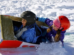 Grade 3 students Ali Badiozamani Tari Naz (left) and Alyssa Smith went for a wild ride in their self-made bobsled during an Olympic bobsled racing event held at Sweetgrass School in Edmonton on Thursday, Feb. 22, 2018.