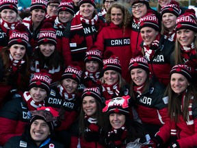 Members of the Canada Olympic Team pose for photos at the end of a welcome ceremony inside the Gangneung Olympic Village.