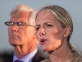 Catherine McKenna, front, Minister of Environment and Climate Change, announces the federal government's approval of the Pacific NorthWest LNG project as Jim Carr, Minister of Natural Resources, listens during a news conference at the Sea Island Coast Guard Base, in Richmond, B.C., on Tuesday September 27, 2016. File photo.