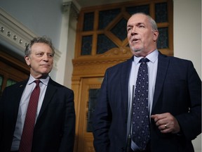 Premier John Horgan and Minister of Environment and Climate Change Strategy George Heyman answer questions about the Alberta dispute during a press conference at the Legislature in Victoria, B.C., on Wednesday February 7, 2018.
