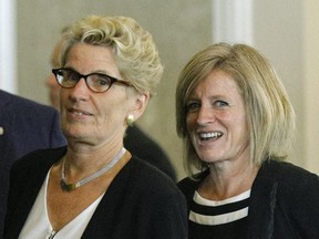 Kathleen Wynne (left, premier of Ontario) and Rachel Notley (right, premier of Alberta) arrive for the closing news conference after a three-day meeting with Canada's provincial Premiers and National Indigenous Organization Leaders in Edmonton on Wednesday July 19, 2017.