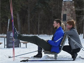 Jeff Kiely puts his feet up or in this case cross country skis, getting ready to take his mother, April Kiely (R), and a friend out skiing along the trails at Victoria Park in Edmonton, February 26, 2018.