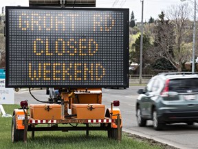 A sign notifying drivers of a nightly road closure of Groat Road is seen near 105 Street and River Valley Road. Edmonton police say so far this year five batteries have been stolen from city display signs.
