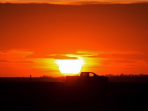 A truck sits on a Sturgeon County road without a driver behind the wheel near St. Albert during a beautiful sunset north of Edmonton, Alta.