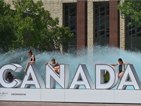 Taking a break on the Canada 150th birthday sign.