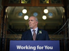 Premier John Horgan answers questions from the media following the speech from the throne in the legislative assembly in Victoria, B.C., on Tuesday, February 13, 2018. THE CANADIAN PRESS/Chad Hipolito ORG XMIT: CAH700