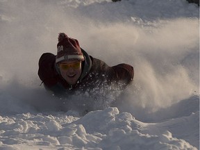 Nikolas Wright takes advantage of all the fresh snow at Gallagher Hill as he and friends slide down on Sunday, Feb. 4, 2018 in Edmonton.