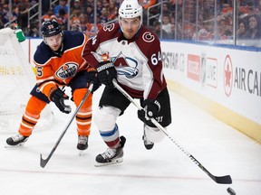 Edmonton Oilers' Mark Letestu (55) pursues Colorado Avalanche's Nail Yakupov (64) during first period NHL action in Edmonton on Thursday, Feb. 1, 2018.
