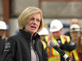 Alberta Premier Rachel Notley speaks with steel workers, company representatives and media during a tour of Tenaris, a manufacturer and supplier of steel pipe products in Calgary on Feb. 9, 2018.