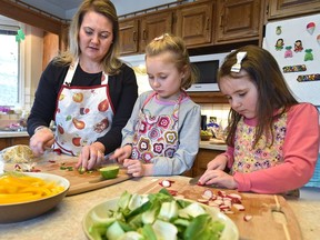 Leanne Bramm and her two girls, Isabella, 7, and Abigail, 5, preparing a meal kit from Chef's Plate delivered to their home in Edmonton on March 14, 2018.