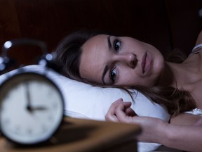 Woman lying in bed. Getty Images/iStock Photo