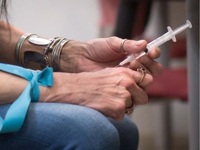 Tracey Loyer injects hydromorphone at the Providence Health Care Crosstown Clinic in the Downtown Eastside of Vancouver, B.C., on April 6, 2016. A Vancouver study suggests severely addicted heroin users could be treated with an injectable pain medication.