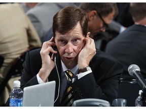 Nashville Predators general manager David Poile works the phones in this file photo from the 2013 NHL draft at the Prudential Center on June 30, 2013 in Newark, New Jersey. (File)