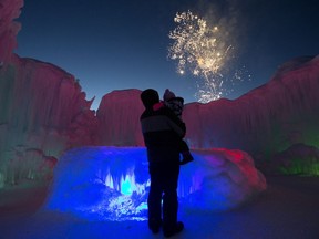 Visitors to the Hawrelak Park Ice Castle watch fireworks during the Silver Skate Festival in Edmonton Sunday, Feb. 18, 2018.