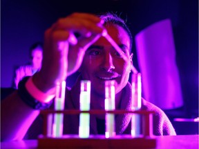 Chris Knockwood takes part in an experiment during Dark Matters at the Telus World of Science Edmonton in Edmonton on Thursday, March 8, 2018.