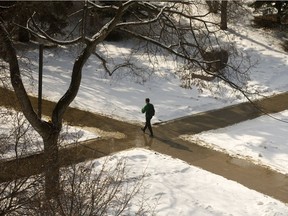 A pedestrian walks through the snow covered quad at the University of Alberta, in Edmonton Tuesday March 27, 2018.