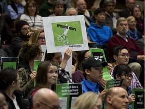 Students hold up protest signs during a campus forum held by University of Alberta president David Turpin, in Edmonton Wednesday March 28, 2018. Photo by David Bloom