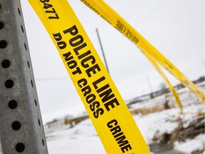 Police tape adorns a sign post near Manning Drive and 18 St where officers were investigating a crime spree in Edmonton on Wednesday, March 28, 2018.