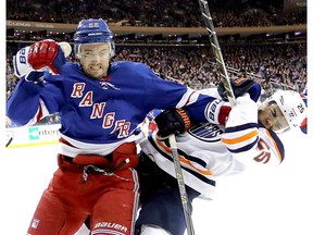 Kevin Shattenkirk of the New York Rangers shoves Darnell Nurse of the Edmonton Oilers at Madison Square Garden on Nov. 11, 2017 in New York City.