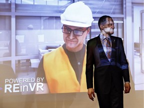 Alberta President of Treasury Board and Minister of Finance Joe Ceci stands in front of a virtual reality character of him, during a pre-budget event in Edmonton Alta, on Tuesday March 20, 2018.