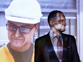 Finance Minister Joe Ceci stands in front of a virtual reality character of him during a pre-budget event in Edmonton on Tuesday March 20, 2018.